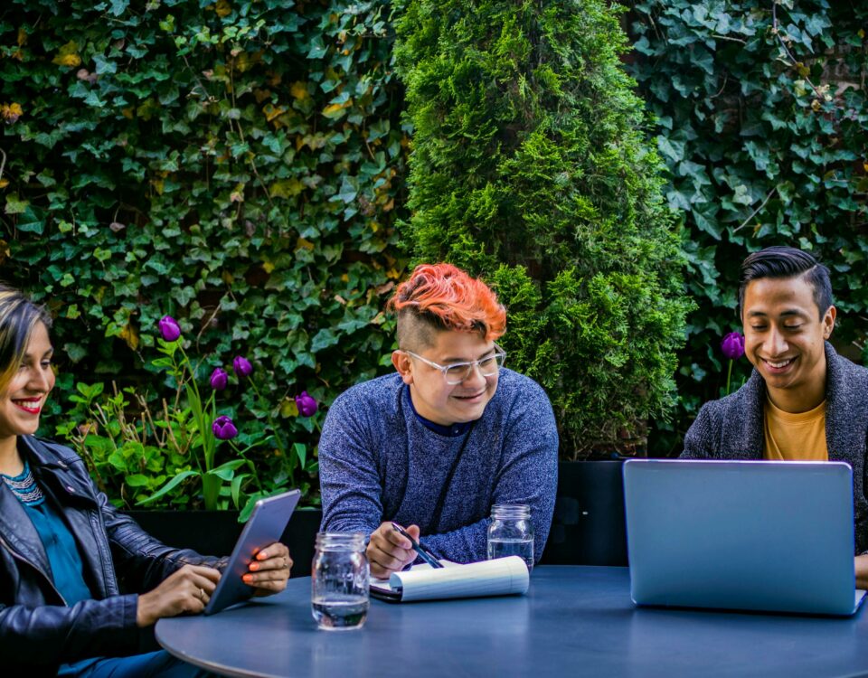 three people sitting together and smiling